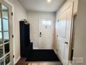 Bright entryway featuring a hall tree, coat rack, and a door with glass inserts at 1047 Campbell Chase Sw Ln, Concord, NC 28025