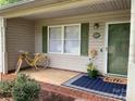 Inviting front porch featuring a yellow bicycle and a blue welcome mat at 1124 St. Charles Ct # 3, Newton, NC 28658