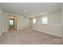 Upstairs loft space with neutral carpet, access to other rooms, and natural light at 117 Canoga Ave, York, SC 29745