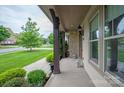 Spacious porch with stone pillars, offering a view of the well-maintained front yard at 1233 Ladera Dr, Waxhaw, NC 28173
