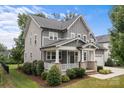 Stylish two-story home with a welcoming front porch and well-manicured landscaping at 124 Slocumb Ln, Mooresville, NC 28117