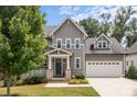 Inviting two-story home featuring a covered front porch and well-maintained lawn at 124 Slocumb Ln, Mooresville, NC 28117
