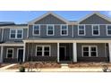 Charming new construction townhome with gray siding, white trim, and a welcoming front porch at 135 Utility Ln # C, Mooresville, NC 28117