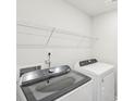 Laundry room featuring a new washer and dryer, along with wire shelving for storage at 135 Utility Ln, Mooresville, NC 28117