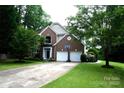 Beautiful two-story home with a well-manicured lawn, two-car garage, and inviting curb appeal at 13934 Kings Carriage Ln, Charlotte, NC 28278
