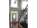 Elegant foyer featuring hardwood floors, a staircase, and an abundance of natural light at 13934 Kings Carriage Ln, Charlotte, NC 28278