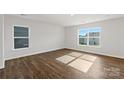 Bright bedroom with hardwood flooring, two large windows and views of the exterior at 1450 Mammoth Rd, Hickory, NC 28602