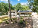 Charming exterior of home with manicured landscaping, brick accents, and lush greenery at 1505 Clarendon Pl, Rock Hill, SC 29732