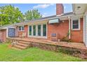 Brick back patio with steps, featuring French doors and exterior brick oven and built in grill at 2178 Tryon Courthouse Rd, Bessemer City, NC 28016