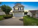 Charming two-story home with a two-car garage and well-maintained lawn, captured during the evening at 2527 Fossil Stone Ln, Fort Mill, SC 29708