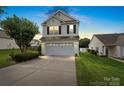 Charming two-story home boasts an attached garage, manicured lawn, and inviting curb appeal at 2527 Fossil Stone Ln, Fort Mill, SC 29708