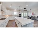 Modern kitchen with white cabinets, large island, pendant lighting, and stainless steel appliances at 264 Auburn View Rd, Rock Hill, SC 29730