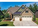 Charming home with a two-car garage, stone accents and manicured lawn at 2972 Arches Bluff Cir, Lancaster, SC 29720