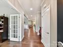 Long hallway featuring hardwood flooring, neutral walls, and an open floor plan at 2972 Arches Bluff Cir, Lancaster, SC 29720