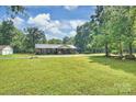 A charming brick home with a large front yard and mature trees, offering a serene setting at 321 York Southern Rd, Fort Mill, SC 29715