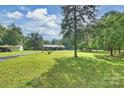 Brick home showcasing large front yard, mature trees, outbuildings and long driveway at 321 York Southern Rd, Fort Mill, SC 29715