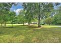 Brick home with large front yard featuring mature shade trees, and outbuildings at 321 York Southern Rd, Fort Mill, SC 29715
