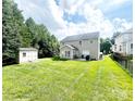 Spacious backyard featuring a well-maintained lawn, shed, and patio area perfect for outdoor entertaining at 4048 Cascade Dr, Gastonia, NC 28056