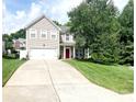 Traditional two-story home with a well-manicured lawn, two-car garage, and inviting red front door at 4048 Cascade Dr, Gastonia, NC 28056