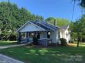 Attractive home with a classic design, complemented by lush greenery and a cozy front porch at 419 W 8Th St, Newton, NC 28658