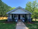 Inviting home showcasing a covered front porch and well-manicured lawn, perfect for relaxation at 419 W 8Th St, Newton, NC 28658