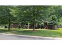 Attractive brick home with lush landscaping and mature trees in a quiet neighborhood at 4742 Emory Ln, Charlotte, NC 28211