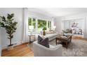 Airy living room with large windows, hardwood floors, and stylish neutral decor at 4742 Emory Ln, Charlotte, NC 28211