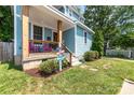 Inviting covered front porch features comfortable seating and decorative landscaping at 501 Mercury St, Charlotte, NC 28205