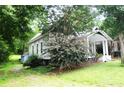 The exterior view showcasing the side of the home and ample greenery at 510 5Th St, Spencer, NC 28159