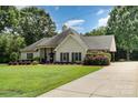 Well-maintained home featuring a lush green lawn, inviting front porch, and attached carport at 5701 Cedar Hill Dr, Monroe, NC 28110