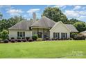 Charming single-story home with lush landscaping and a welcoming front porch at 5701 Cedar Hill Dr, Monroe, NC 28110