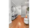 Hallway with wood floors, decorative mirror, and access to other rooms at 5730 Closeburn Rd # N, Charlotte, NC 28210
