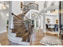 Grand foyer showcasing a beautiful curved staircase and hardwood flooring at 6327 Fox Tail Ln, Davidson, NC 28036