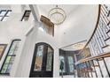 Impressive two-story foyer with modern lighting and a wrought iron front door at 6327 Fox Tail Ln, Davidson, NC 28036