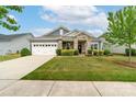 Charming single-story home with a well-manicured lawn, stone accents, and a two-car garage at 732 Wood Lily Dr, Belmont, NC 28012