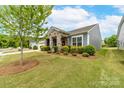 Charming home with manicured lawn, featuring stone accents and vibrant green landscaping at 732 Wood Lily Dr, Belmont, NC 28012