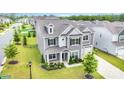 Beautifully landscaped gray home with manicured lawn and a two-car garage at 8420 Golden Stone Ln # 138, Fort Mill, SC 29707