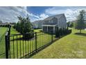 Fenced backyard with green lawn and landscaping that enhances the appeal of this home at 8420 Golden Stone Ln # 138, Fort Mill, SC 29707