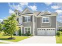 Attractive two-story home with a well-maintained lawn and an attached two-car garage at 8420 Golden Stone Ln # 138, Fort Mill, SC 29707