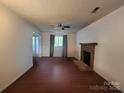 Traditional living room offering sleek wood floors, brick fireplace and ample natural light at 8904 Daventry Pl, Charlotte, NC 28215