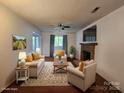 Comfortable living room with a brick fireplace, neutral paint, and nice wood flooring at 8904 Daventry Pl, Charlotte, NC 28215