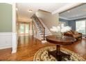 Foyer showcasing staircase, hardwood floors, and decorative details at 9212 John Hawks Rd, Cornelius, NC 28031