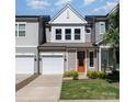 Beautiful new construction townhome features an orange front door, lush lawn, and a one car garage at 9221 Widden Way, Charlotte, NC 28269