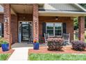 Inviting front porch with rocking chairs, elegant planters, and a 'Welcome' sign at 101 Harvest Farm Ct, Mount Holly, NC 28120