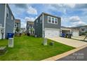 Rear two-car garage with ample parking and lawn space in a modern neighborhood at 10209 Mamillion Dr, Huntersville, NC 28078