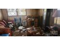 Cluttered living room featuring a sofa, desk, speakers, and miscellaneous items at 1116 Bryce Ave, Salisbury, NC 28144