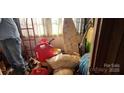 Messy storage room with various containers, an ironing board, and a ladder at 1116 Bryce Ave, Salisbury, NC 28144