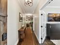 A long foyer with wood floors, a console table, and an open view into the living area at 1118 Yale Pl, Charlotte, NC 28209