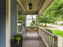 Relaxing front porch with porch swing, plants, and view of street at 1118 Yale Pl, Charlotte, NC 28209