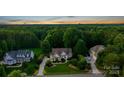 Aerial view of a home with lush greenery and mature trees in a desirable neighborhood at 132 Ragsdale Trl, Mooresville, NC 28117